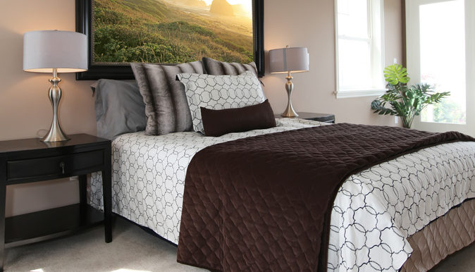 Modern brown and white bed with nightstands.